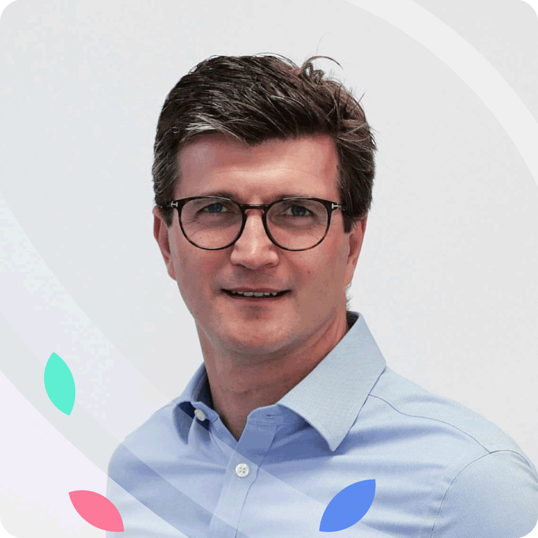 a portrait photograph of LendingMetrics' CCO Matthew Addison wearing a light blue shirt on a white background with a frame of petal graphics