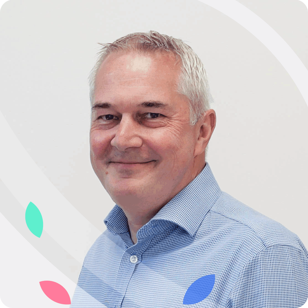 a portrait photograph of LendingMetrics' Rob Cox wearing a light blue shirt on a white background with a frame of petal graphics