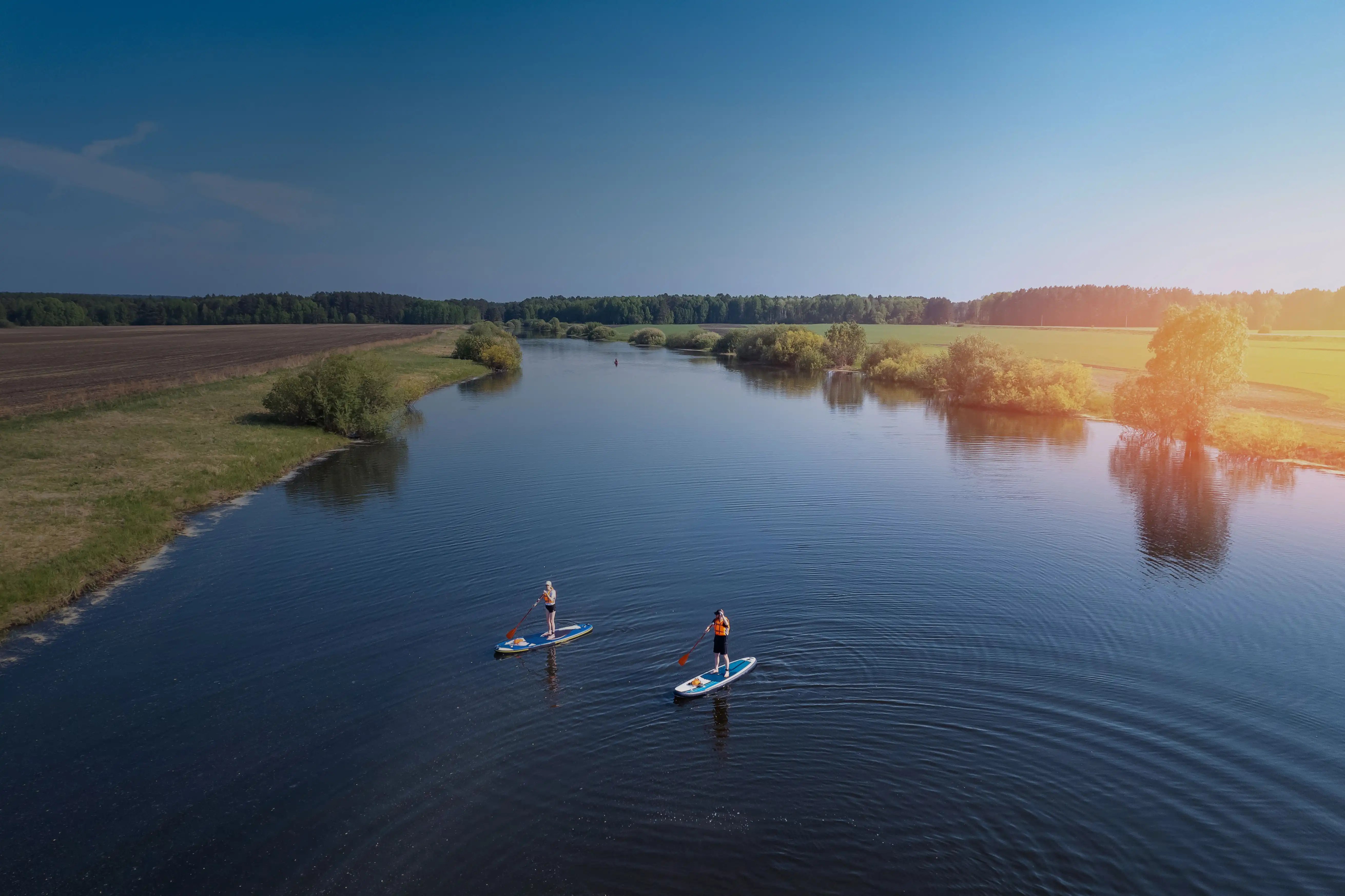 picturesque lake with individuals paddleboarding
