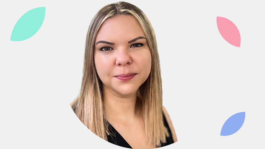 portrait photo of claire januszczak, lenidngmetrics head of sales, looking straight at the camera, surrounded by lendingmetrics petals