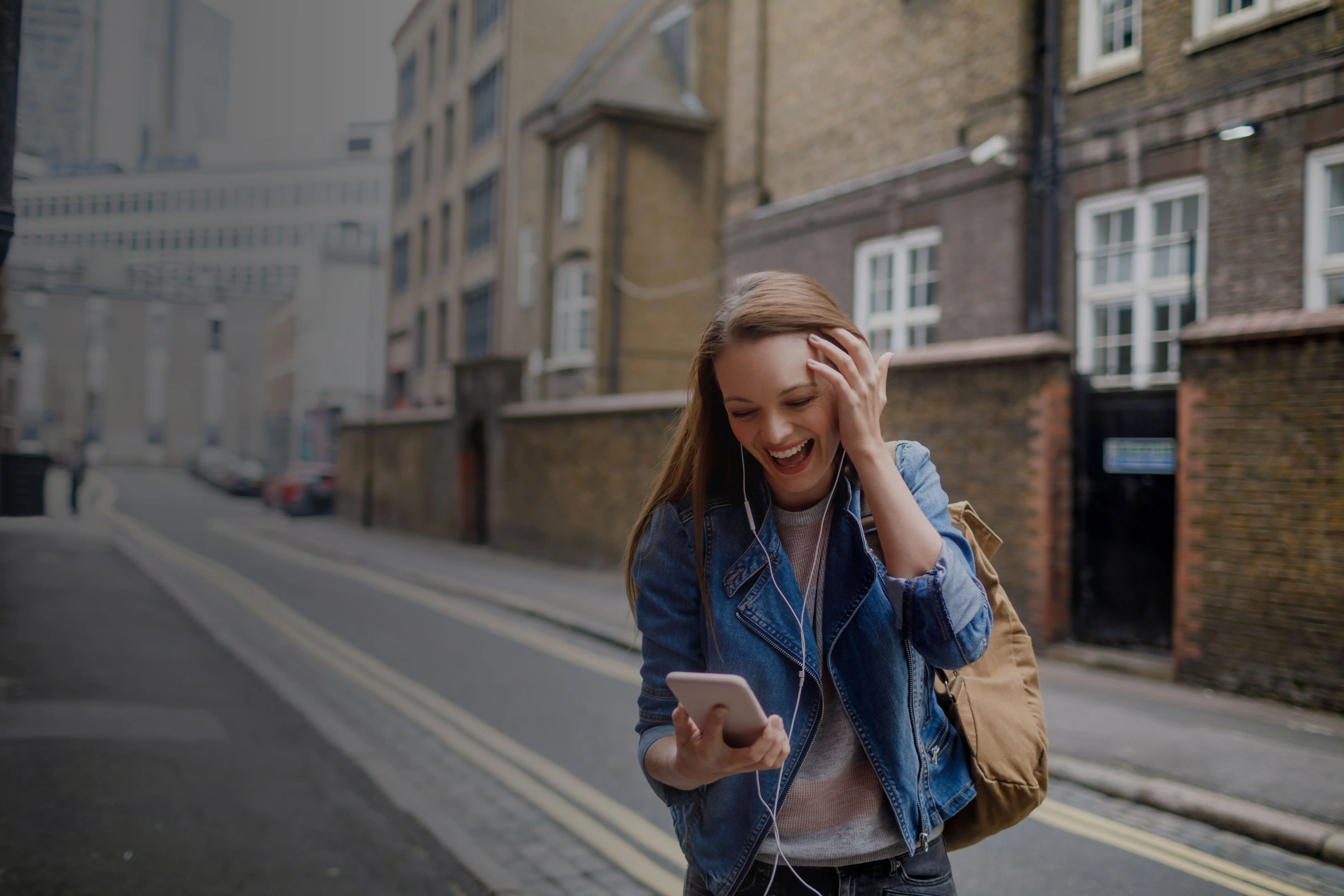 young woman looking at data on phone in urban area